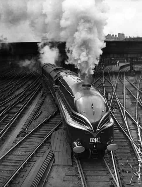 1938: The new LMS streamlined locomotive Duchess of Gloucester leaves Euston Station in London on her first long distance journey. She is transporting fifteen German railway experts to a summer meeting of the Institute of Locomotive Engineers in Glasgow
