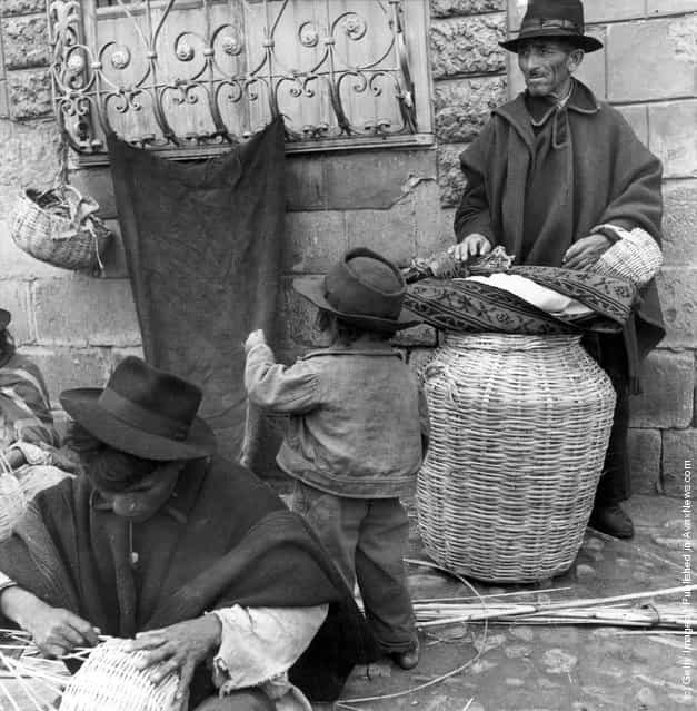 1955: Craftsmen weaving baskets in the Plaza San Alfonso, Riobamba, Ecuador, whilst waiting for customers