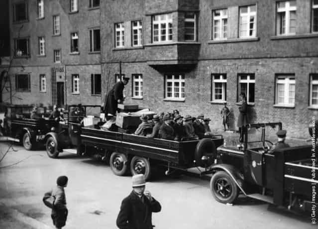 The Berlin police raid a community of artists and journalists in South West Berlin. Trucks containing confiscated material and prisoners are being driven away, 1933