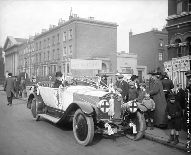 Mr W Weekes drives a Rolls Royce decorated with slogans promoting Our Day, which collects fund to help soldiers at the front during World War I, 1916