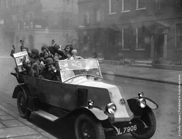 1925: A car full of Ragged Children, who have received Christmas presents