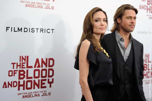 Director/actor Angelina Jolie and actor Brad Pitt pose for a photo during the premiere of In the Land of Blood and Honey at the School of Visual Arts