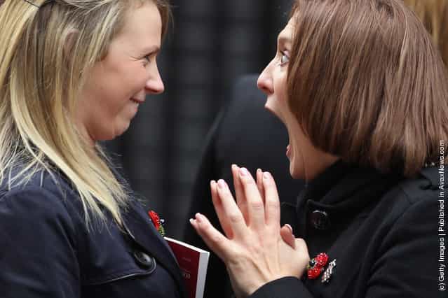 Women from the military wives choir joke before singing outside Number 10 Downing Street ahead of a reception with British Prime Minister David Cameron for returning British troops who were involved in operations in Libya
