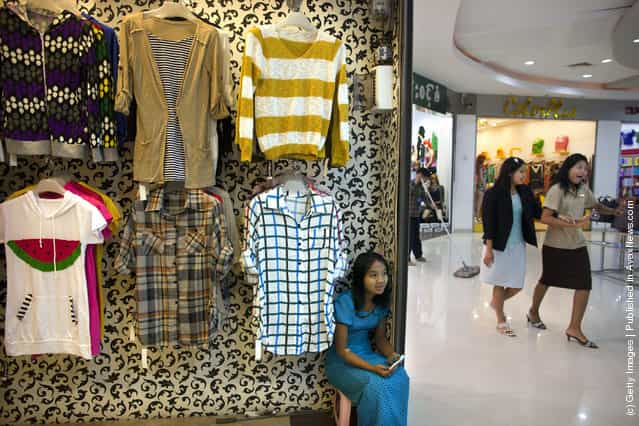 A Burmese woman waits for business at a shop inside a shopping mall