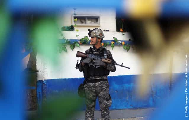 An Iraq Police officer mans a checkpoint decorated with plastic flowers