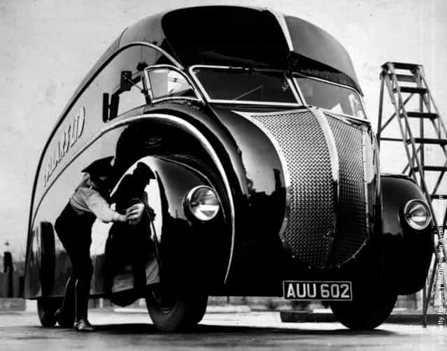 A driver polishes his new streamlined lorry upon its arrival at Wembley, London. The lorry is mounted on a Commer two-ton chassis, 1933