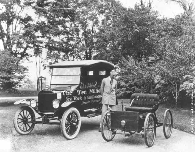 American motor vehicle industry pioneer Henry Ford (1863 - 1947) standing next to the first and the ten millionth Model-T Ford, 1924