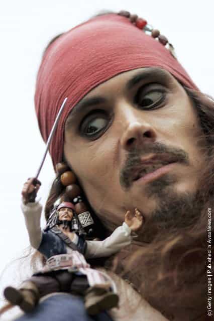 A Jack Sparrow look-a-like poses with a toy version of the Pirates of Caribbean character, at the Dream Toys 2006