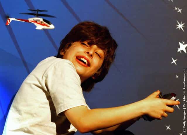 A young boy plays with a Silver lit Picooz remote control helicopter during the Dream Toys 2007 Christmas predictions fair