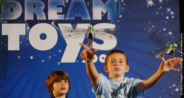 A young boys plays with remote control Flytech Dragonfly toys during the Dream Toys 2007 Christmas predictions fair