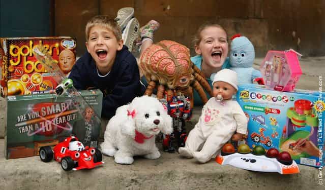 Children pose for photographs with the Dream Toys predicted Top 12 toys for Christmas during the Dream Toys 2007 Christmas predictions fair