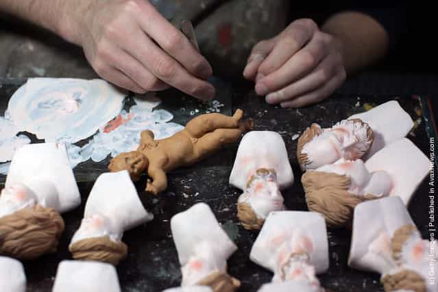 An artisan works on Neapolitan Christmas Nativity figurines at Maestri Ferrigno, which opened in 1836, at Via San Gregorio Armeno
