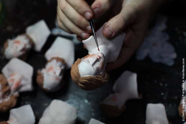 An artisan works on Neapolitan Christmas Nativity figurines at Maestri Ferrigno, which opened in 1836, at Via San Gregorio Armeno