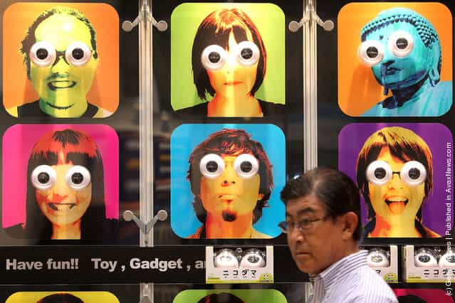 A visitor walks past Cube Co., Ltds toy eyeballs Nikodama displayed during the International Tokyo Toy Show 2010