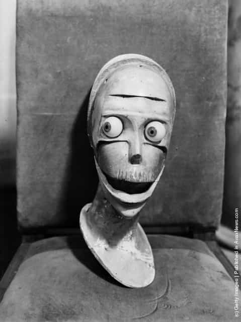 1933: A stylised sculpted head with staring eyes and gaping mouth