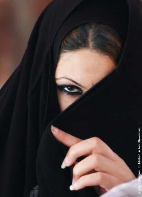 An newly married Iraqi woman looks on during a group wedding celebration in al-Muhsin Shiite mosque
