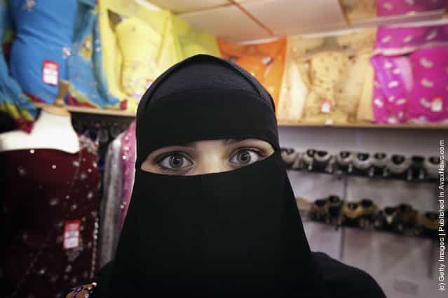 A Muslim woman wearing a Niqab poses inside an Asian fashion shop in the British northern town of Blackburn, the constituency of Member of Parliament Jack Straw, where a quarter of his constituents are Muslim