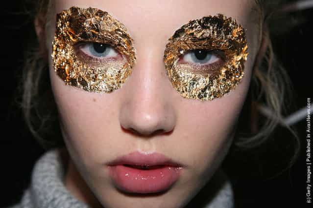 A model has gold leaf eye make-up applied backstage ahead of the Konstantina Mittas catwalk show at the Overseas Passenger Terminal, Circular Quay on day three of Rosemount Australian Fashion Week Spring/Summer 2009/10