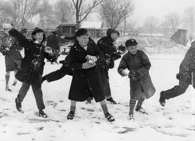 1958: A snowball fight in a school playground in Chiswick, London