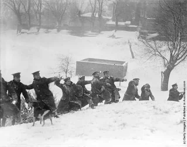 1917: Uniformed men enjoying a snowball fight in London