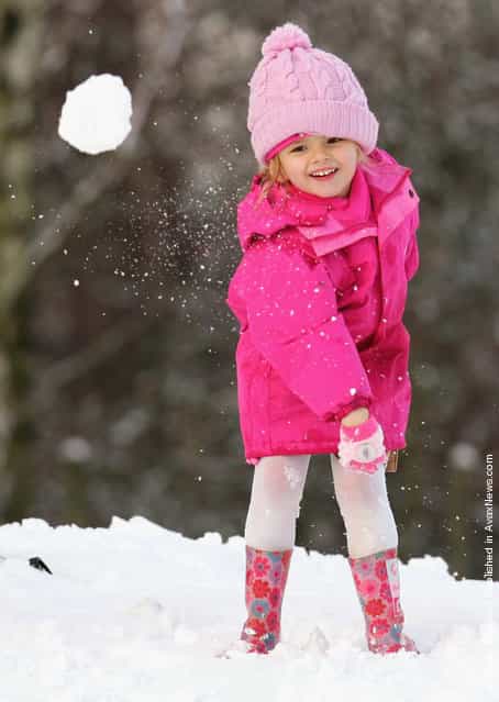 Amy Ward thows a snowball at her father on a snow covered hill