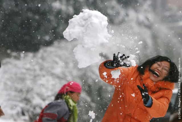 Residents have a snowball fight at a field in Nanjing of Jiangsu Province, China