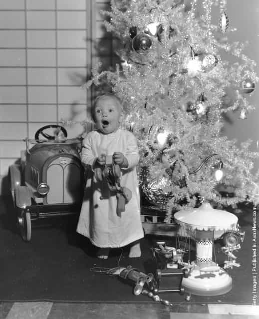 1933: One-year-old Paramount child star Baby LeRoy plays with his new toys under the Christmas tree