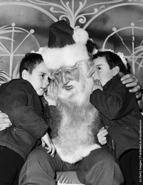 1970: A pair of five year old twins tell Father Christmas what they want for their presents at Selfidges in Oxford Street