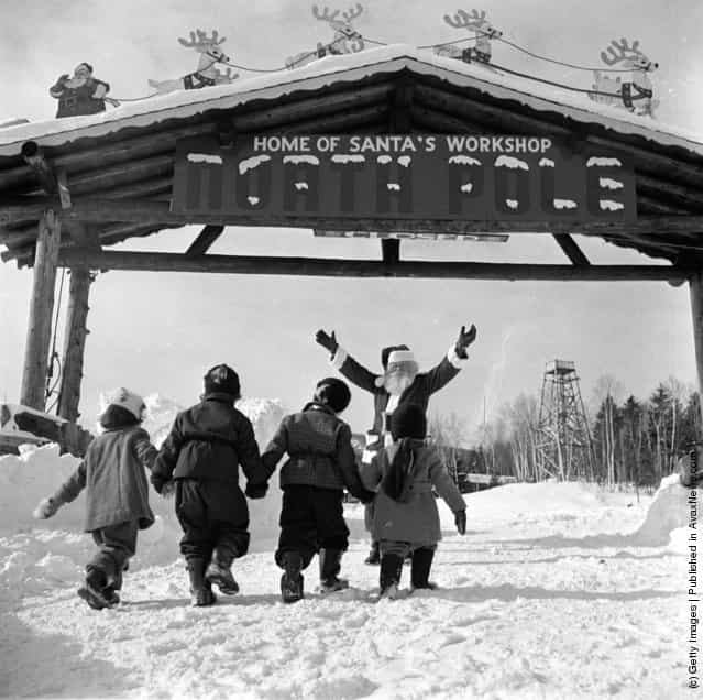 1955: Santa Claus welcomes young visitors to his North Pole Workshop in the Adirondack Mountains of New York State