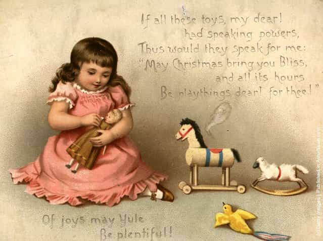 1873: A Christmas greetings card showing a child playing with her toys