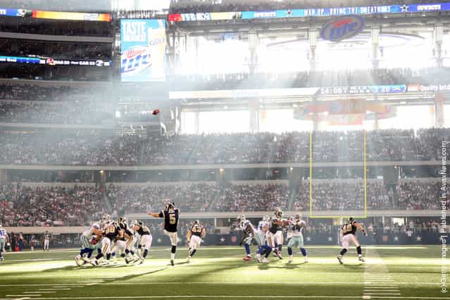 Donnie Jones #5 of the St. Louis Rams punts into the sun against the Dallas Cowboys at Cowboys Stadium
