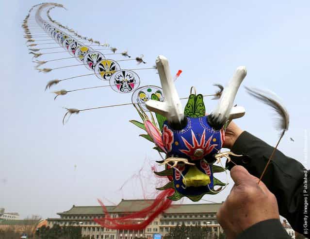 A man flies a dragon-shaped kite at a square on March 31, 2006 in Changchun of Jilin Province, China