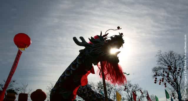 Athletes play a Dragon Dance during a new year temple fair held at the Longtan Lake Park