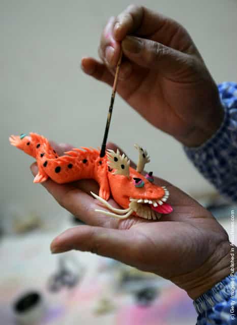 A villager paints a dough dragon on January 3, 2008 in Xian of Shaanxi Province, China. Dough flowers (or flowery bread) are very popular in the Chinese countryside
