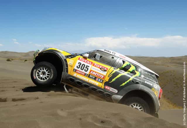 Nani Roma of Spain drives his Mini over a sand dune on stage two of the 2012 Dakar Rally