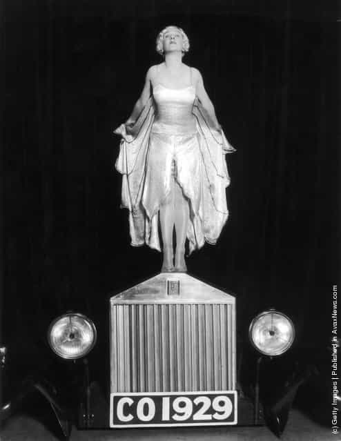 1929: Entertainer Elsa McFarlane stands on the bonnet of a Rolls Royce car, mimicking the Silver Lady figurine, in a production of The Co-Optimists, at the Vaudeville Theatre in London