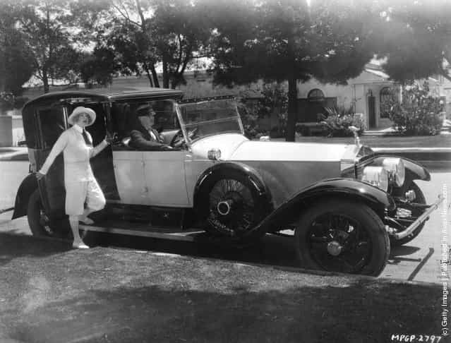 1929: Mae Murray, the radiant Hollywood film star and actress signed by MGM. Seen about to board her Rolls Royce