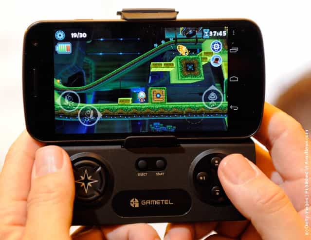 A Gametel wireless controller by Fructel is used to play a video game on a smartphone during a press event at The Venetian for the 2012 International Consumer Electronics Show (CES)