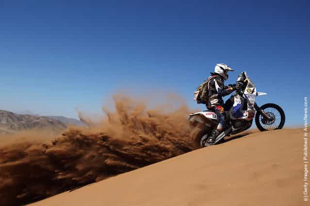Neil Scott Williams of South Africa and the Memo-Tours Alfie Cox Team rides up a sand dune during stage seven of the 2012 Dakar Rally