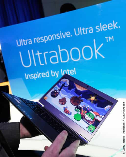 A conference attendee handles Toshiba Ultrabook on display at the Intel booth at the 2012 International Consumer Electronics Show