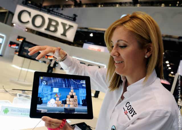 Coby representative Danay Stockton displays the Coby MID-9742-8 tablet at the 2012 International Consumer Electronics Show