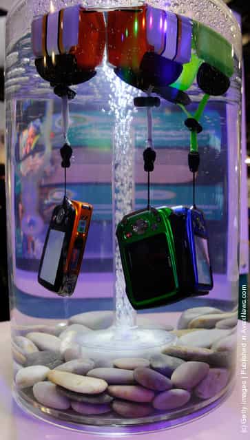 Fujifilm FinePix digital cameras are displayed in water to demonstrate that they are waterproof (up to to 32.8 feet) at the 2012 International Consumer Electronics Show
