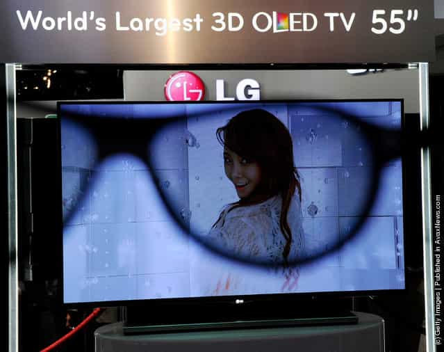An LG 55-inch 3-D OLED TV is is partially seen through a pair of 3-D glasses at the LG Electronics booth at the 2012 International Consumer Electronics Show