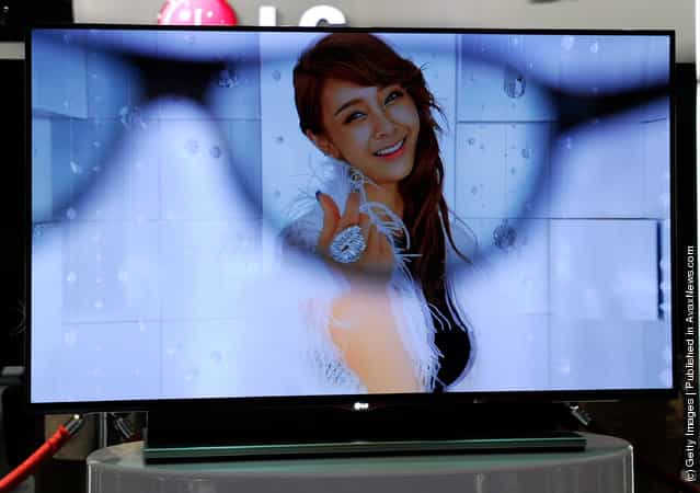 An LG 55-inch 3-D OLED TV is is partially seen through a pair of 3-D glasses at the LG Electronics booth at the 2012 International Consumer Electronics Show