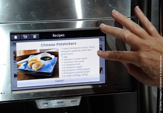 An attendee uses an interface on a refrigerator using LGs newest Smart ThinQ technology at the LG Electronics booth at the 2012 International Consumer Electronics Show
