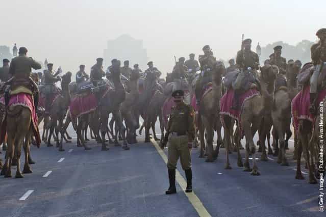 Indian soldiers mounted on camels march in preparation for the upcoming Republic Day parade