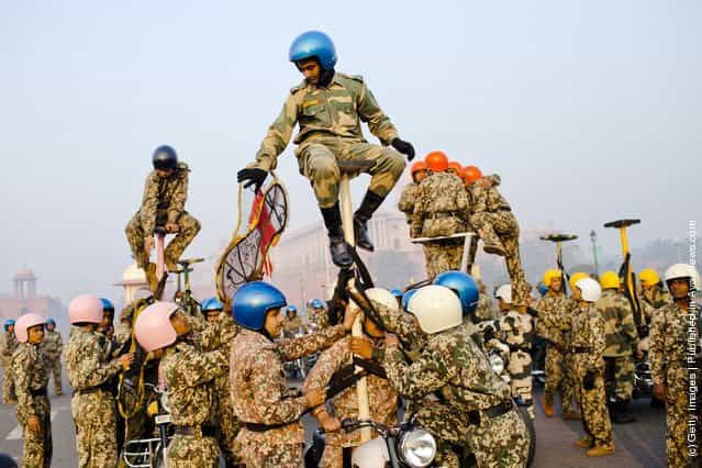 Indian soldiers practice their stunts on Royal Enfield motorcycles in preparation for the upcoming Republic Day parade
