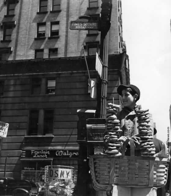 1947: A pretzel vendor selling his wares from a wicker basket in the Times Square and Broadway area of New York
