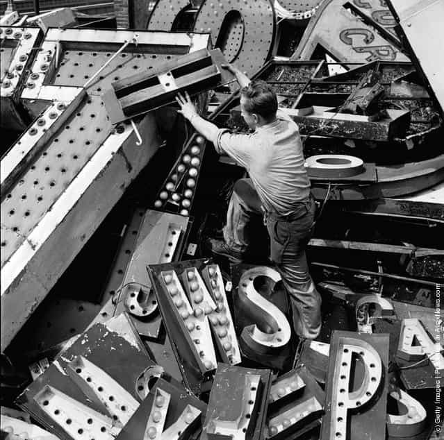 1950: Old signs reclaimed by neon sign making company Art-Craft Strauss. Many of their signs adorn New Yorks Times Square