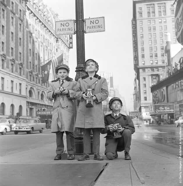 1956: Choristers from a Norwegian choir on a visit to New York take photographs in Times Square